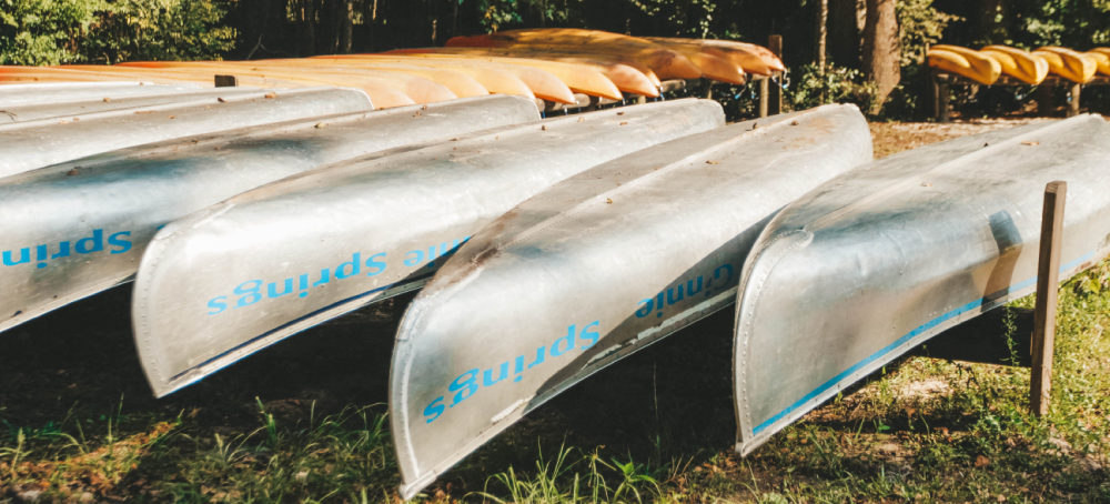 Image of a fleet of canoes waiting to hit the water at Ginnie Springs